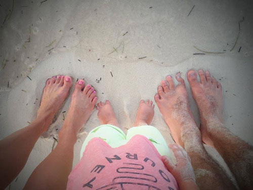 Rob Howard&rsquo;s family standing barefoot in the sand at the beach